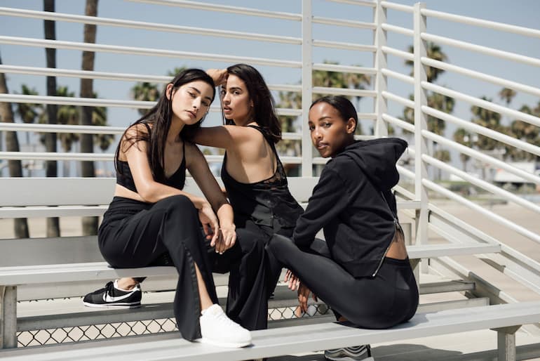 Three girls wearing streetwear clothes