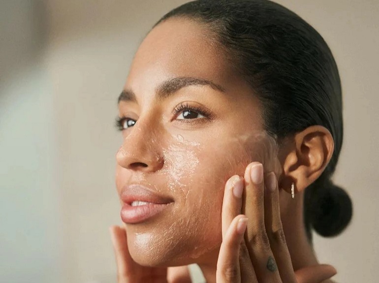 Woman cleansing her face